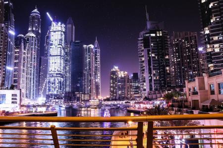 Boats on Body of Water Surrounded by High Rise Buildings