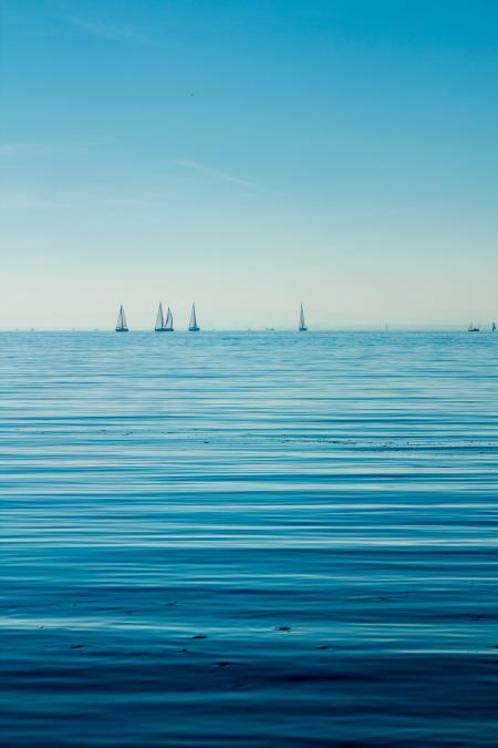 Boats on Body of Water Under Blue Sky