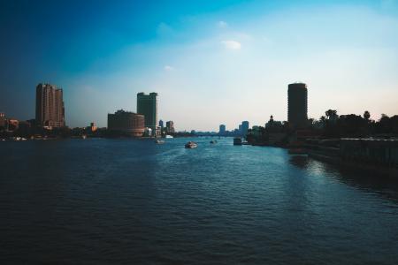 Boats on Water With High Rise Building Background