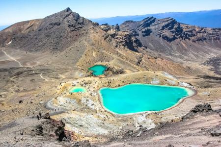 Bodies of Water Surrounding Mountain during Daytime