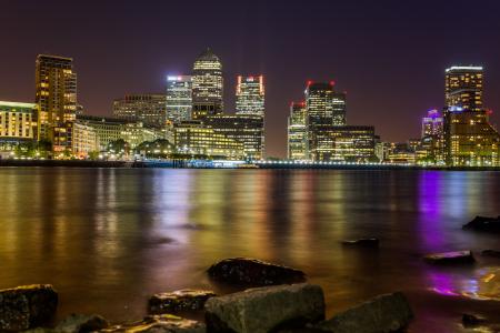 Body of Water Across City Buildings during Night