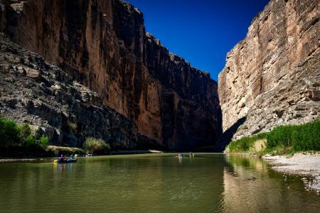 Body of Water Between Rocky Mountain Under Clear Blue Sky during Daytime