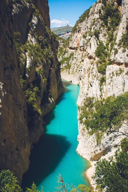 Body of Water in Between of Rock Formation Under Blue Sky at Daytime