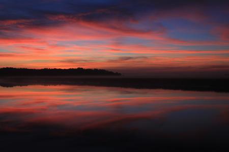 Body of Water Under Blue Red and Yellow Sunset Sky