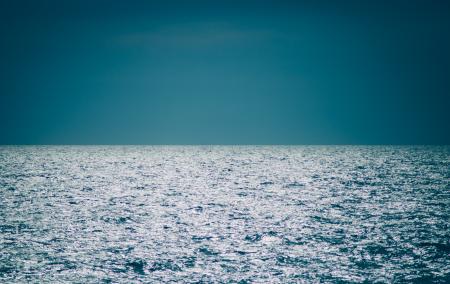 Body of Water Under Clear Blue Sky