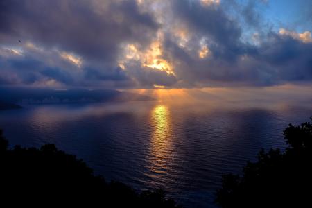 Body of Water Under Cloudy Blue Sky