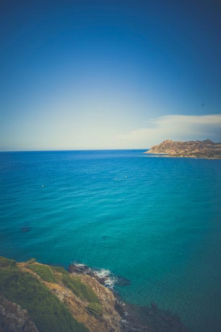 Body of Water With Brown Ad Green Mountain Photo