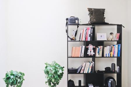 Books and Speakers on Black Wooden Shelf