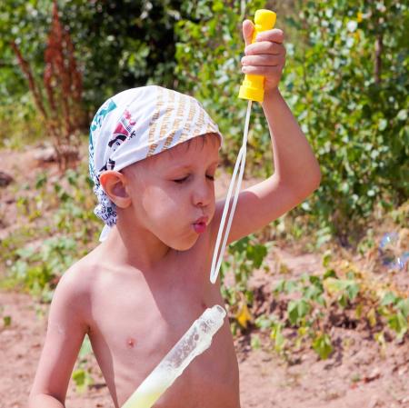 Boy blowing soap bubbles