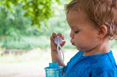 Boy child blowing bubbles