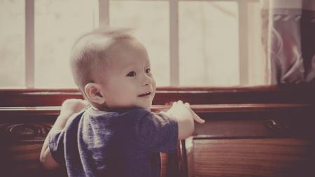 Boy in Blue Crew Neck Shirt Standing in Front of Window