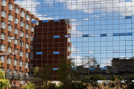 Brick Building in Glass Building Reflection