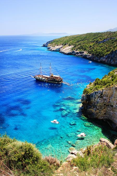 Brown and White Boat on Blue Seashore