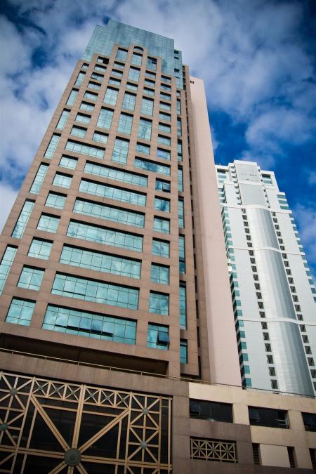 Brown and White Concrete Building Under White and Blue Cloudy Sky