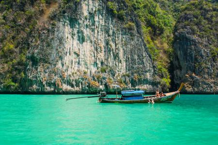 Brown Blue Boat Near Cliff and Water