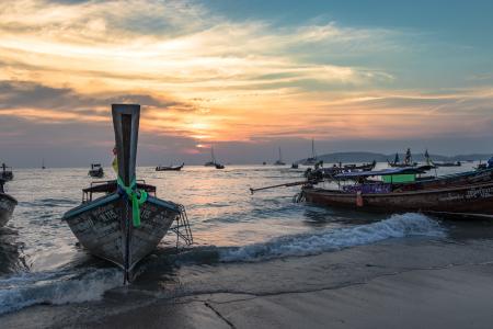 Brown Boat Near Body of Water during Sunset