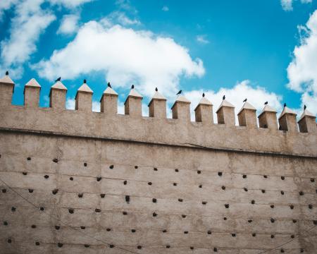 Brown Concrete Castle Wall Under Cumulos Clouds