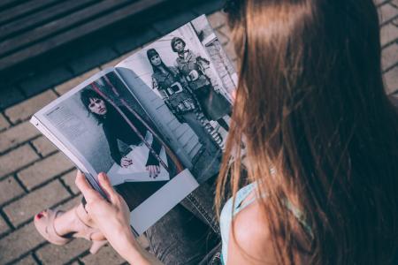 Brown Haired Female Reading Magazine