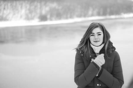 Brown Haired Woman in Black Puffer Coat Standing Near the Water