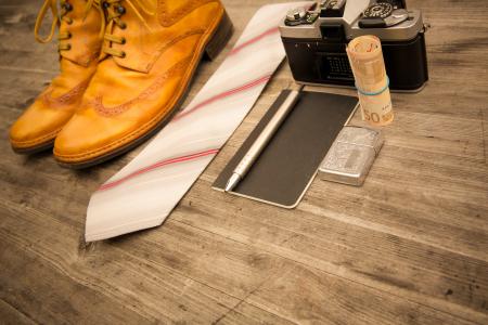 Brown Leather Oxford Wingtip Shoes Beside White and Pink Necktie on Brown Wooden Table