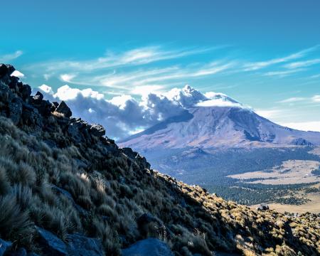 Brown Mountain Under White Clouds and Blue Sky
