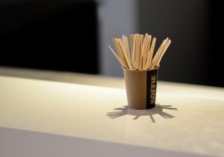 Brown Popsicle Sticks in Brown Disposable Cup