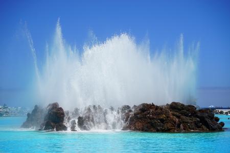 Brown Rock Island on Sea Water Under Blue Sky during Daytime