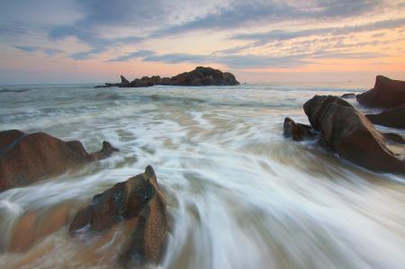 Brown Rocks Near a Body of Water during Daytime