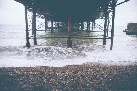 Brown Sand Beside Seashore and Wave of Water during Day Time
