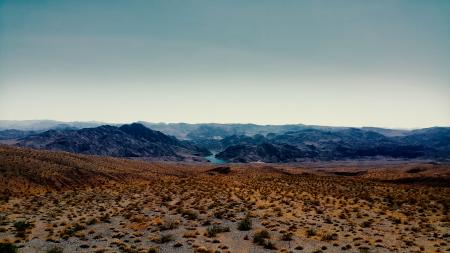 Brown Sand Near Mountain Under Cloudy Sky