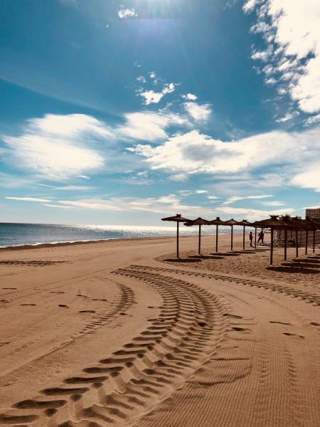 Brown Sand Near Seashore Under Cloudy Sky