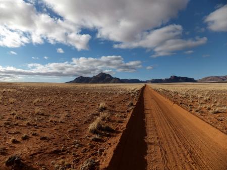 Brown Sandy Field Under Blue and White Cloudy Sky