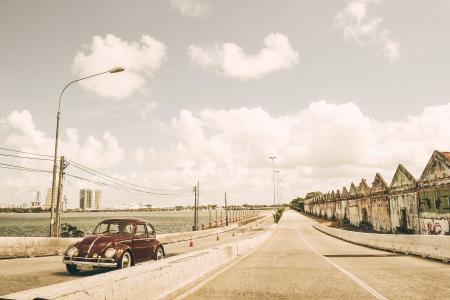 Brown Volkswagen Beetle on Asphalt Road