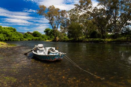 Brown Water Boat Floating on Body of Water