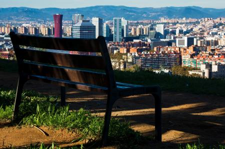 Brown Wooden Bench With Metal Frame Surrounded by Building Scenery