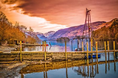 Brown Wooden Bridge Near Mountains and Body of Water