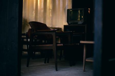 Brown Wooden Chair and Gray Crt Tv