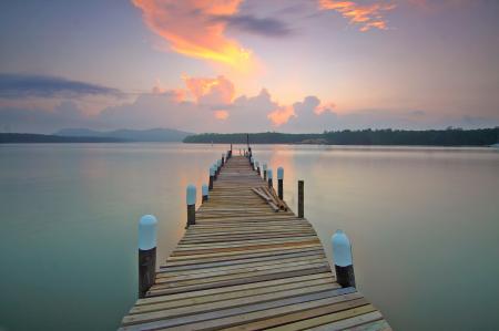 Brown Wooden Footbridge on Body of Water during Sunrise