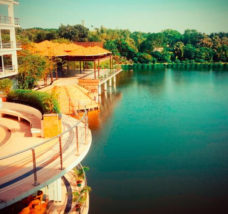 Brown Wooden House Beside Gazebos Near Body Of Water