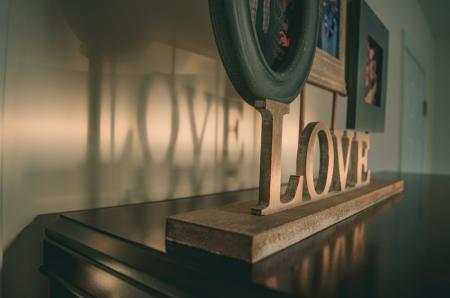 Brown Wooden Love Free Standing Letter on Black Wooden Surface