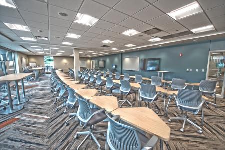 Brown Wooden Triangular Tables and Gray Rolling Chairs Inside Room