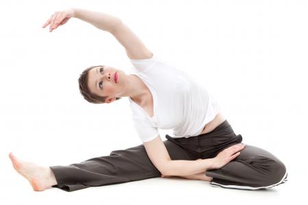 Brunette Short Haired Woman Stretching Arm Overhead in Yoga Pose