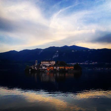 Buildings Near Body Of Water And Mountain