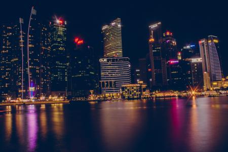 Buildings Near Body Of Water During Night Time