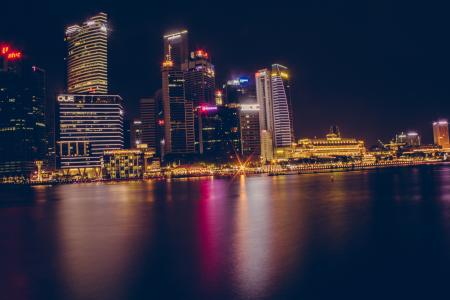 Buildings Near Body Of Water During Night Time