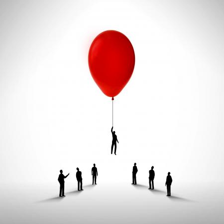 Businessman rising by holding a balloon