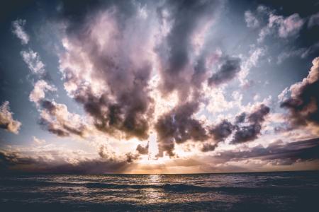 Calm Body of Water With Cloudy Skies