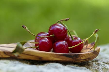 Cherries in wooden spoon