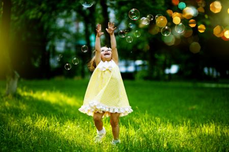 Child chasing bubbles