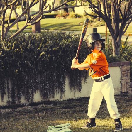 Child Holding Bat during Daytime